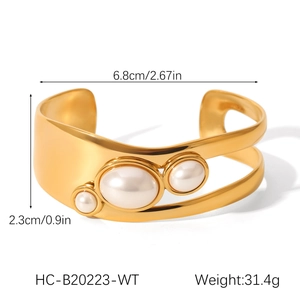Detail view of gold stainless steel bangle with asymmetrical pearls and size measurements