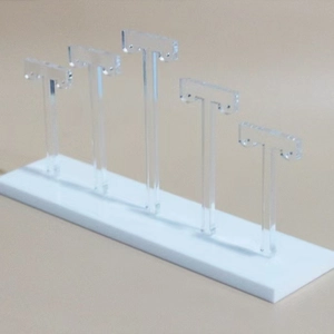 Detailed view of 5-tier acrylic T-bar earring display stand with clear holders and white base