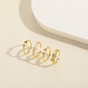 Set of four gold-plated open rings with zircon, star charms and geometric designs