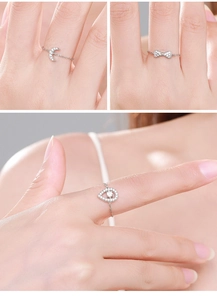 Detail of adjustable S925 silver chain rings with moon, bow, and teardrop charms