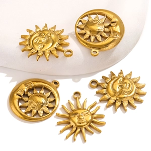 Detailed view of gold celestial sun and moon charms with embossed faces for DIY jewelry