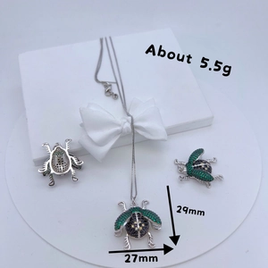 Detailed beetle pendant with green and black zircons on silver plated copper base