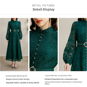 Close-up of floral lace texture on a dark green dress with metallic belt buckle