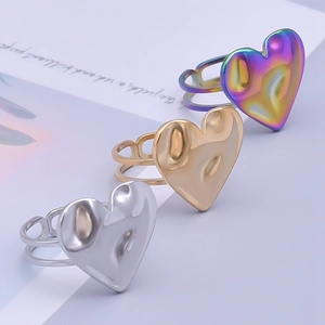 Detailed view of silver, gold, and rainbow heart rings with molten lava texture