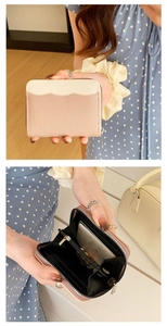 Detail of pink and beige leather coin purse showing zipper pocket and card slots