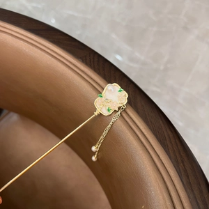 Detail of vintage gold hair stick with pink flower, white pearls and long tassels