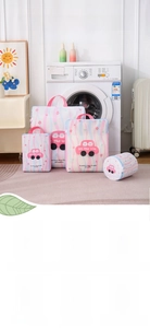Detail of printed mesh laundry bag with blue wave pattern and pink carrying handles