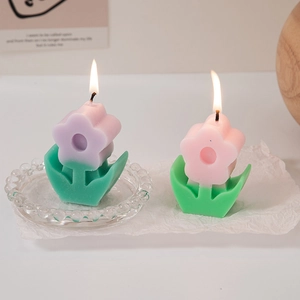 Cute pink and purple flower scented candles in full bloom with a warm aesthetic
