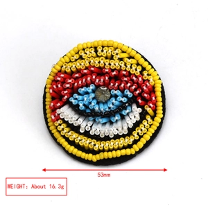 Detail of colorful Evil Eye embroidery brooch with 53mm size and 16.3g weight specs