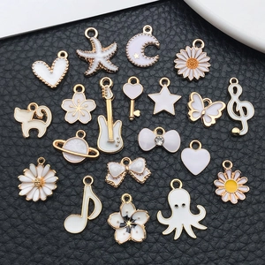 White and gold enamel alloy charm set featuring hearts stars and musical note shapes