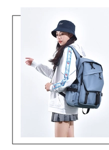 Side view of blue nylon backpack featuring multiple compartments and adjustable black straps