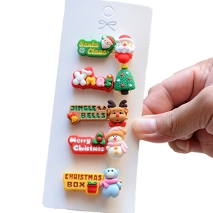 Close-up of a 5-piece Christmas hair clip set featuring Santa Claus and reindeer designs