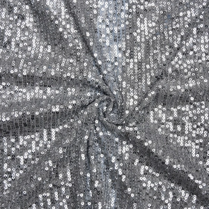 Close-up of sparkling silver sequins stitched on mesh fabric for vintage shirts