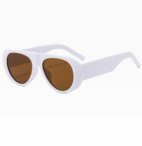 Detail of white oval sunglasses with thick frames and brown lenses from a 45-degree angle