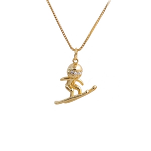 Macro view of gold-plated skateboarder pendant featuring sparkling zircon stone eyes