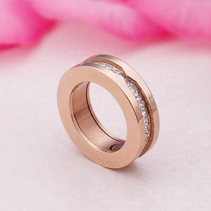 Rose gold stainless steel wide ring with centered white cubic zirconia pavé setting