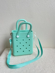 Detail of mint green EVA tote bag with ventilation holes and woven shoulder strap