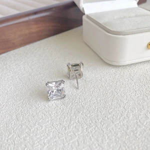 Macro shot of square-cut cubic zirconia stud earrings in sterling silver setting