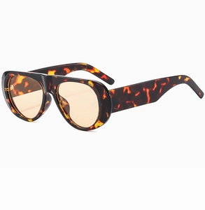 Detail of tortoise shell sunglasses frame with light orange lenses in 45-degree angle