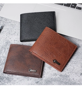 Close-up of business leather wallets in black and brown with fine stitching and metal detail