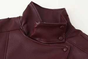 Detail of burgundy PU leather jacket collar with double buttons and fine stitching