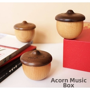 Detail of acorn-shaped wooden music box featuring dual-tone beech and walnut textures