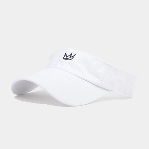 Close-up of white sun visor hat with black crown embroidery and cotton fabric detail