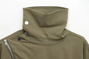 Detail of military green jacket high neck with silver metal buttons and diagonal zipper