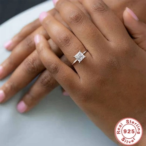 Close-up of a square cut diamond ring in 925 sterling silver on a model hand