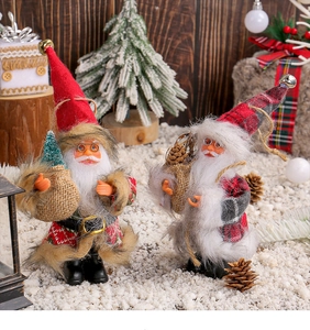 Detail view of plush Santa figures with knit outfits and miniature Christmas trees