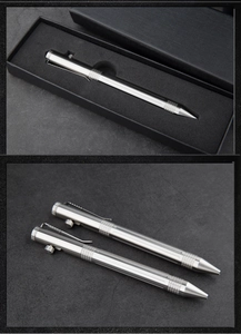 Close-up of stainless steel tactical pen with industrial grip in a textured gift box