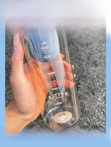 Detailed view of clear 650ml capacity scale on a minimalist brown water bottle