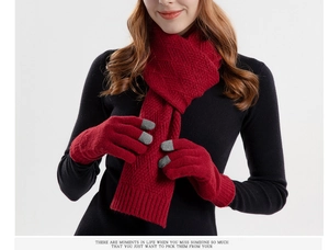 Detail of red knitted scarf and touchscreen gloves set with wavy knit texture