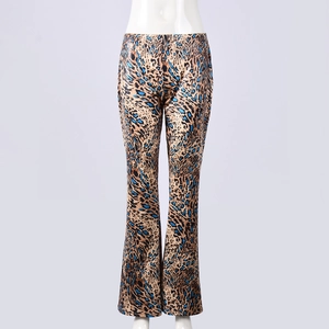 Close-up of leopard print flare pants with blue spots and slim fit stretch fabric