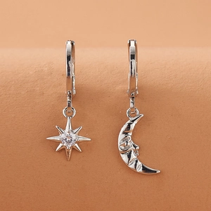 Elegant asymmetric star and moon hoop earrings with cubic zirconia in silver finish