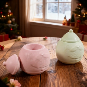 Detail of pink and mint green Santa Claus storage jars with festive embossed faces