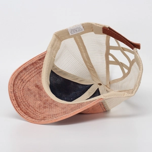 Detail view of washed cotton baseball cap with mesh back and criss-cross ponytail elastic band