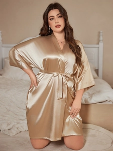 Detail of champagne gold satin robe with kimono sleeves and matching waist tie belt