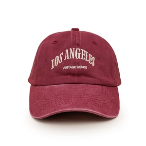 Close-up of vintage washed cotton baseball cap in burgundy with white embroidery