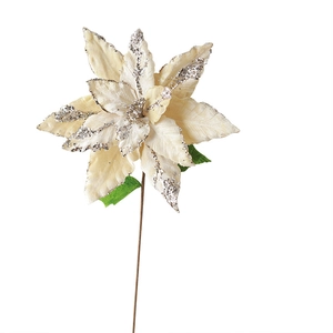 Large cream velvet poinsettia Christmas flower with silver glitter accents and green leaves