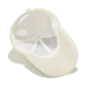Detailed interior of a white sherpa baseball cap showing the lining and velcro strap