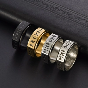 Close-up of Norse Viking rune rings in black, gold, silver and vintage steel finishes