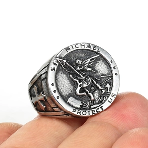 Macro shot of St. Michael Protect Us vintage steel ring with archangel relief