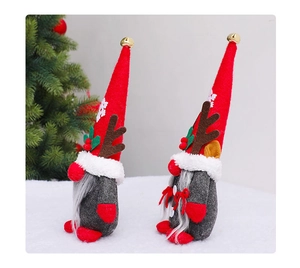Detail of Christmas gnomes with reindeer antlers and snowflake hats in winter setting