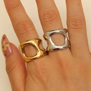 Abstract 18K gold and silver hollow geometric open rings shown on model's hand
