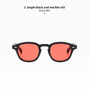 Detail of retro round glasses with glossy black frame, red lenses, and silver arrow accents