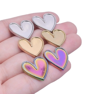 Macro detail of heart-shaped 304 stainless steel pendants in gold, silver and rainbow colors