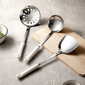 3-piece stainless steel kitchen tool set with white ceramic handles on a wooden board