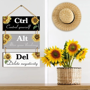 Detail of wooden wall plaques with sunflowers and Ctrl Alt Del inspirational quotes