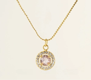 Detail of pink zircon pendant with golden stainless steel frame and crystal halo